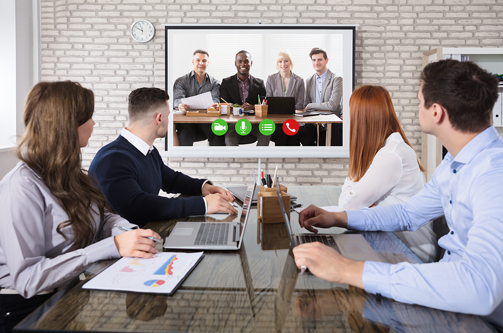 Users gathered around teleconference screen